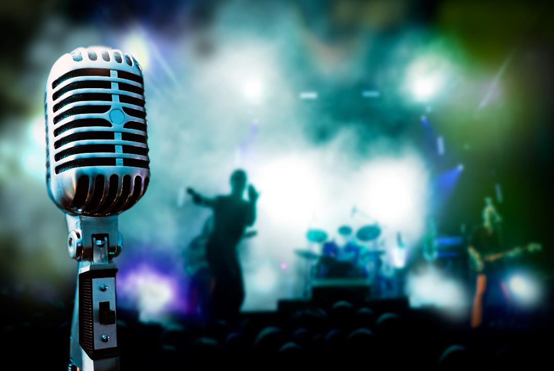 microphone with a concert in the background