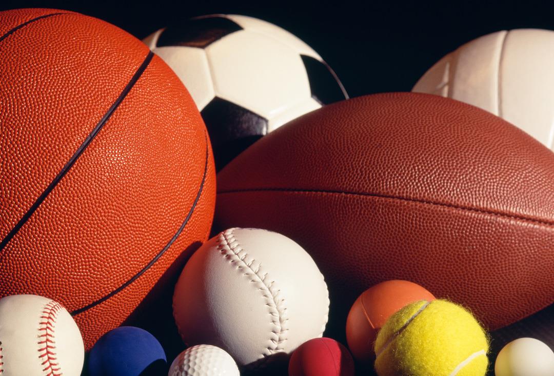 a large variety of sport balls arranged around each other