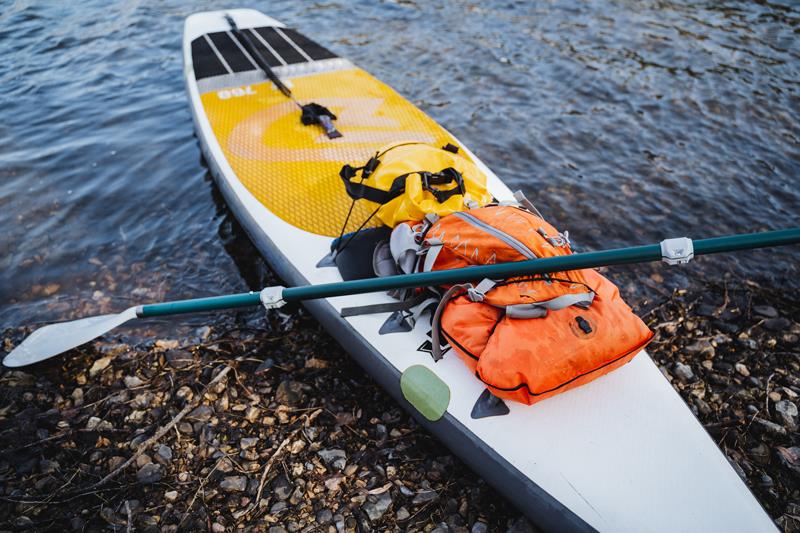 paddle board on the water with a life jacket